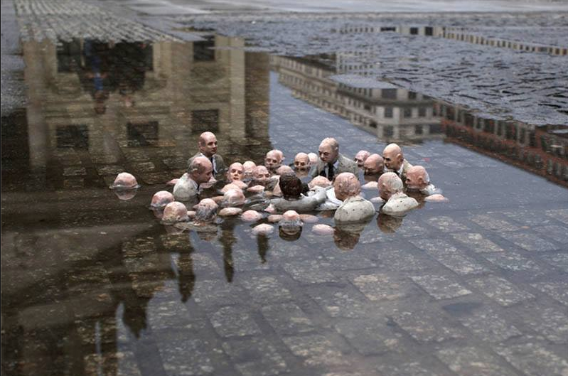 This sculpture by Isaac Cordal in Berlin is called "Politicians discussing global warming."